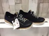 Two navy blue women's sneakers are displayed on a white shelf against a light wood-paneled background. One shoe is slightly in front of the other, with a tag attached to the front shoe. Produktbild-Vorschau
