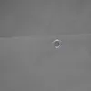 A close-up view of a gray fabric with a metal grommet. Anteprima dell’immagine prodotto