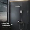 A modern shower system with a rain showerhead and handheld showerhead is displayed against a dark tiled wall, with a window showing a landscape on the left. Produktbild-Vorschau