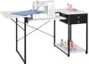A sewing machine is placed on a white sewing table with black legs and drawers. Several spools of thread are also visible on the table and a lower shelf. Podgląd zdjęcia produktu