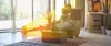 A man is reading a book in a comfortable armchair, with a heater emitting warm air towards him. Produktbild-Vorschau