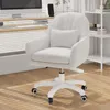 A white velvet office chair with a small pillow is shown in a well-lit room with wooden floors and blinds. Voir les images du produit