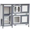 A multi-level wooden hutch for small animals, such as rabbits or guinea pigs, is shown against a white background. Produktbild-Vorschau