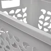 A close-up view of the side of a gray laundry basket with a decorative pattern. Anteprima dell’immagine prodotto