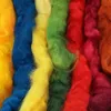 Close-up view of several strands of colorful wool roving. Produktbild-Vorschau