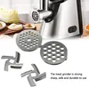 Close-up of meat grinder accessories with a meat grinder in the background. Produktbild-Vorschau