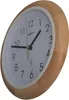 A close-up, angled view of a round wall clock with a wooden frame and a white face. Anteprima dell’immagine prodotto