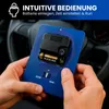 Hands holding a blue device with a clock mechanism and batteries, with a car steering wheel in the background. Náhled obrázku produktu