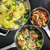 Three pans of food are arranged on a black surface, suggesting a cooking demonstration or a meal preparation scene. Podgląd zdjęcia produktu