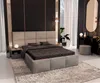 A bedroom with a large bed, nightstand, and dresser with a mirror. Produktbild-Vorschau