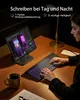 A person is using a backlit keyboard and a tablet on a wooden desk. Produktbild-Vorschau