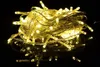 A tangled ball of warm white LED string lights on a reflective black surface. Produktbild-Vorschau