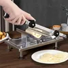 A person is using a manual meat slicer to cut lotus root. Produktbild-Vorschau