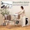 A woman is using a foldable drying rack with clothes on it, next to a washing machine. Anteprima dell’immagine prodotto