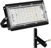 A black LED floodlight with a clear lens and visible LEDs, shown with its mounting bracket and wires. Produktbild-Vorschau