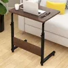 A small wooden table with a laptop and a cup on it, placed next to a sofa. Anteprima dell’immagine prodotto