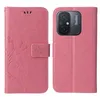 A pink flip phone case with a floral and butterfly design is shown open, revealing the inside and the phone it protects. Produktbild-Vorschau