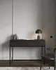 A minimalist desk with a lamp and books on it, next to a chair. Anteprima dell’immagine prodotto