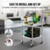 A workshop or garage setting with tools and equipment, focusing on the assembly of a stainless steel worktable. Produktbild-Vorschau