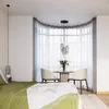 A bedroom scene with a bed, a small dining area by a bay window, and decorative lighting. Podgląd zdjęcia produktu