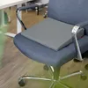 A gray ergonomic seat cushion is placed on a dark gray office chair. Produktbild-Vorschau
