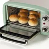 A retro-style toaster oven with several buns inside, its glass door is open. Anteprima dell’immagine prodotto