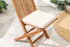 A close-up of a wooden garden chair with a beige cushion, placed on a tiled patio. Produktbild-Vorschau