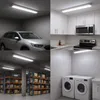 A collage of four images showing a linear LED light fixture installed in different settings: a garage with a car, a kitchen, a warehouse, and a laundry room. Produktbild-Vorschau