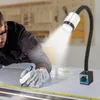 A person is working on a metal surface with a measuring tape, illuminated by a gooseneck LED lamp with a magnetic base. Podgląd zdjęcia produktu
