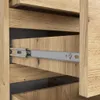 Close-up view of a wooden drawer with metal slides. Produktbild-Vorschau