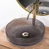 A close-up shot of a glass vessel sink with a gold faucet. Anteprima dell’immagine prodotto