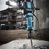 A heavy-duty demolition hammer is shown in a construction site environment. Anteprima dell’immagine prodotto