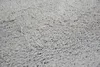 A close-up, textured view of a gray shaggy rug. Produktbild-Vorschau