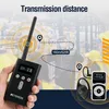 A hand holding a Retekess T130P tour guide system transmitter, with a diagram illustrating transmission distance and a receiver with an earphone shown separately. Produktbild-Vorschau