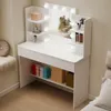 A white vanity table with a lighted mirror, shelves, and drawers, set in a room. Náhled obrázku produktu