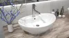 A bathroom countertop with a sink, faucet, and decorative items. Náhled obrázku produktu