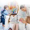 A collage showing a child painting and another child washing their hands with a parent. Voir les images du produit