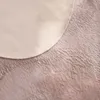 A close-up view of a fluffy rug with a circular beige section overlapping a pink textured section. Produktbild-Vorschau
