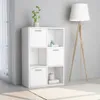 A white storage cabinet with six compartments, some with doors, is shown in a room with a floor lamp and a plant. Náhled obrázku produktu