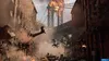 A city street scene with a bridge in the background, explosions, smoke, and military vehicles. Produktbild-Vorschau
