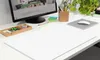 A clean desk setup with a computer monitor, stationery, and a large white writing mat. Náhľad obrázku produktu