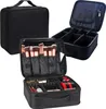 Three black cosmetic bags are displayed against a white background. One is closed and standing upright, another is open and showing its internal compartments, and the third is open and filled with makeup brushes and products. Náhľad obrázku produktu