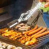 A person is grilling various types of meat and hot dogs on a barbecue grill. Podgląd zdjęcia produktu