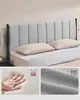 A bed with a headboard, pillows, and close-ups of fabric and hand pressing into foam. Náhled obrázku produktu