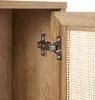 Close-up of a cabinet hinge on a wooden cabinet door with a rattan front. Podgląd zdjęcia produktu