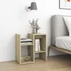 A bedside table with books and a vase of flowers next to a bed. Produktbild-Vorschau