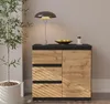 A sideboard with drawers and a door, next to a potted plant, with a lamp and a bowl of fruit on top. Produktbild-Vorschau