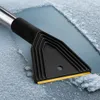 A close-up of an ice scraper with a black handle and a yellow blade, scraping ice off a surface. Produktbild-Vorschau