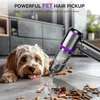 A dog is lying on the floor next to a cordless vacuum cleaner that is picking up debris. Produktbild-Vorschau