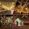 A collage of four images showing various outdoor and street scenes decorated with warm white LED icicle lights, suggesting their use for festive decoration. Produktbild-Vorschau